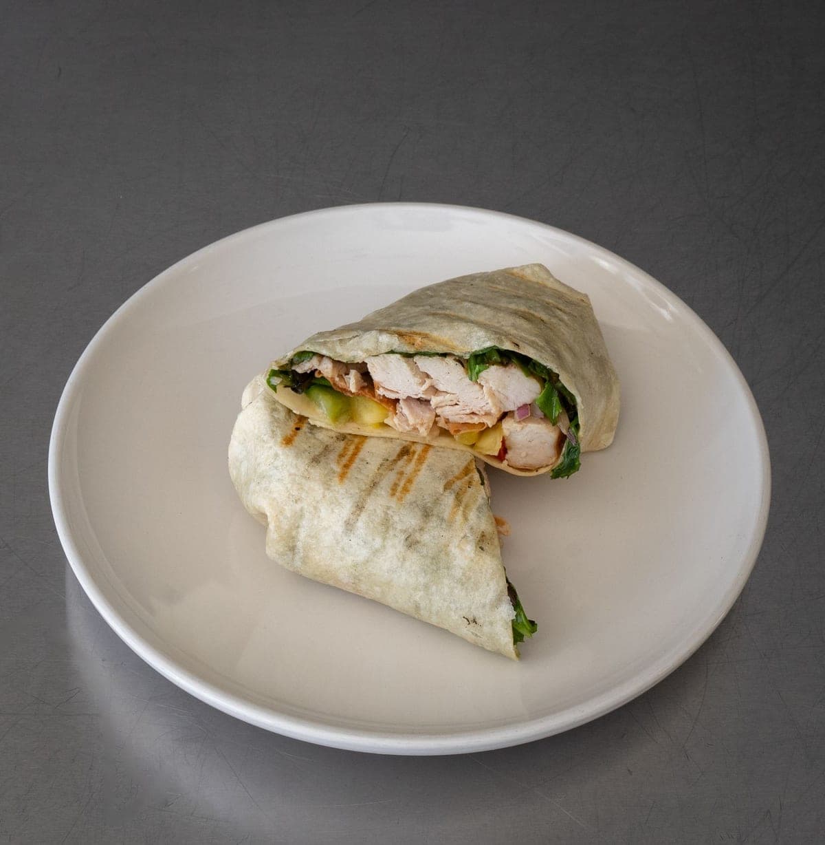 Grilled chicken wrap sliced in half