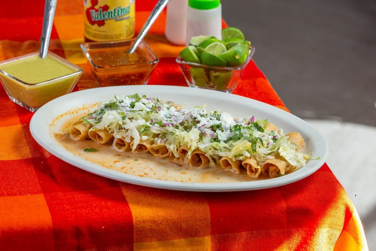 Crispy rolled mini tacos with salsa